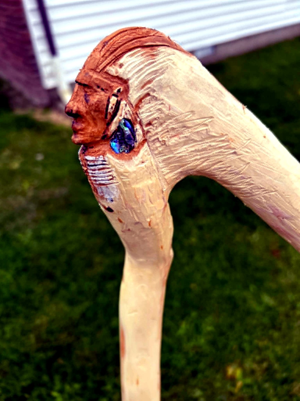 Hand-carved cane handle with profile portrait and inlay detail